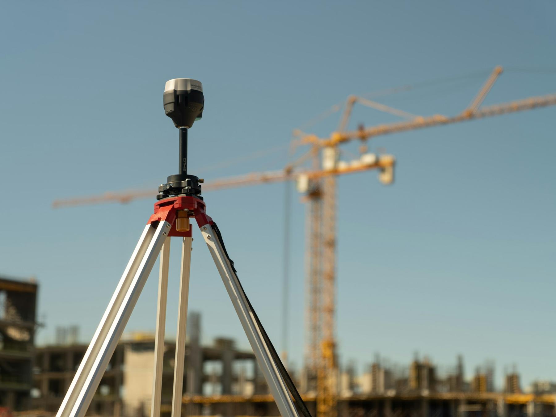 Survey instrument on a tripod at a construction site
